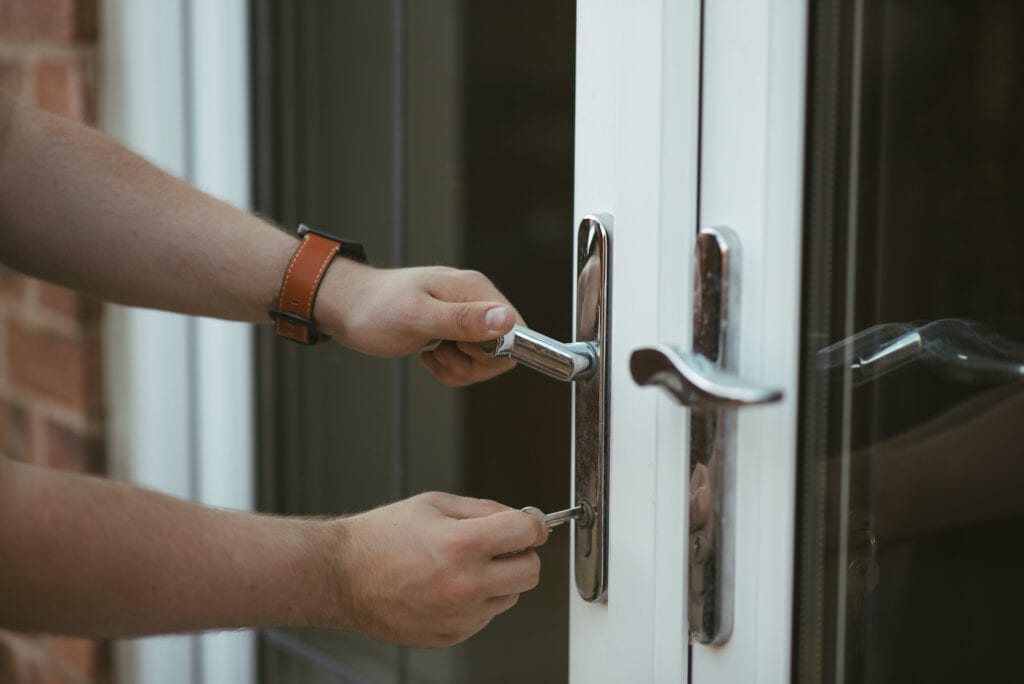 A locksmith assisting with getting into  a locked door.